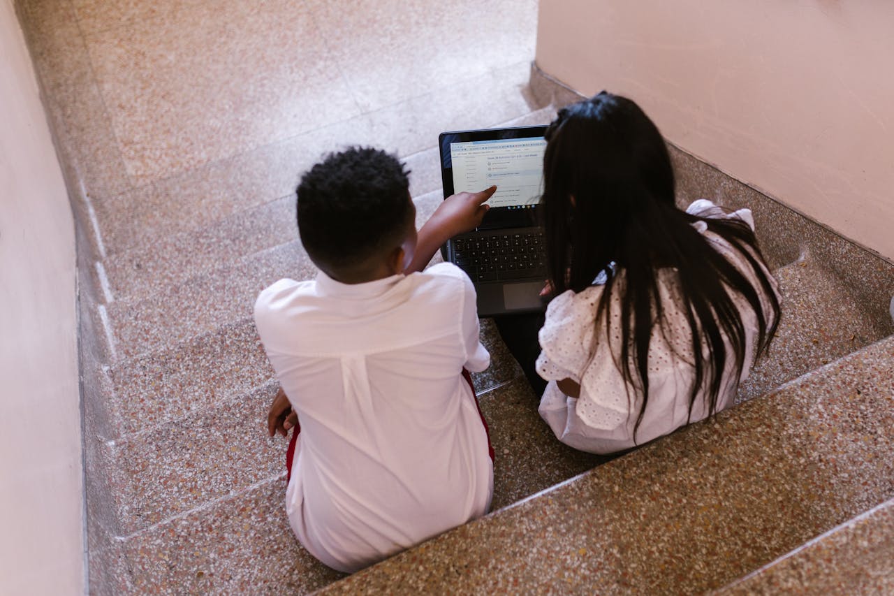 Two students sitting on  the stairs